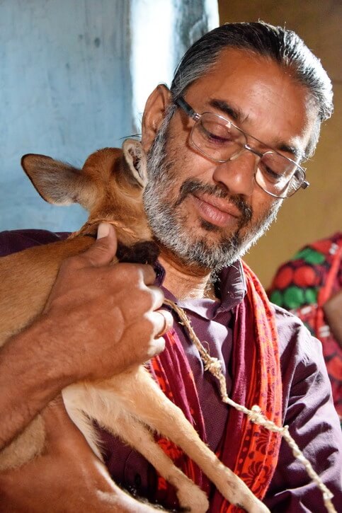 Shakeel with the barking deer putting his head for a hug as a thank you for his care