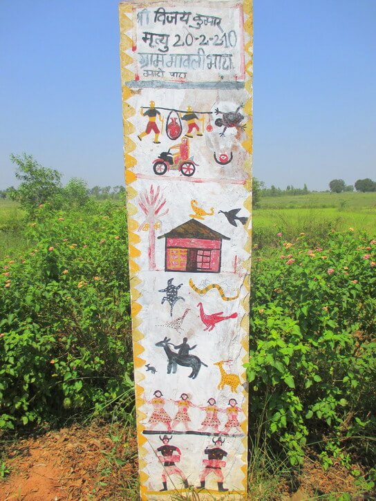 A white memory pillar with different scenes like bison horn Marias or a house