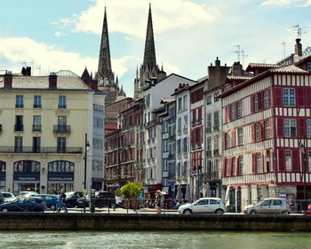 The Basque Country France The cathedral of Bayonne wit the stilt houses and the quay