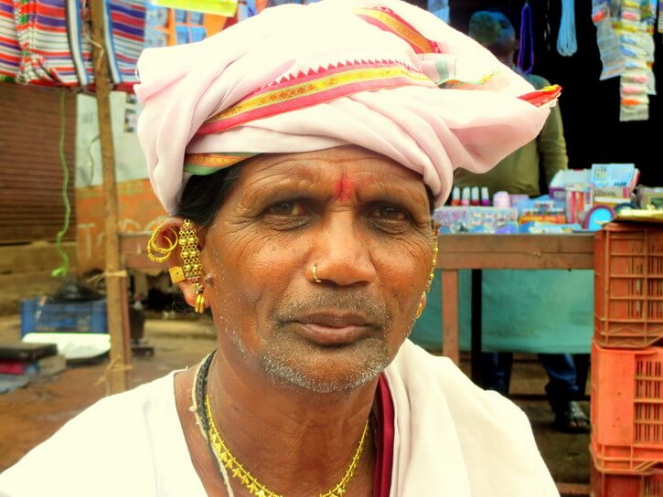 Tribal man from Jagdalpur Chhattisgarh wearing a white and orange turban and Tribal jewels