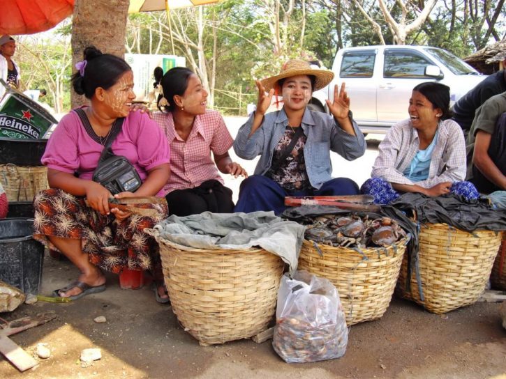 A group of female sellers wearing thanaka