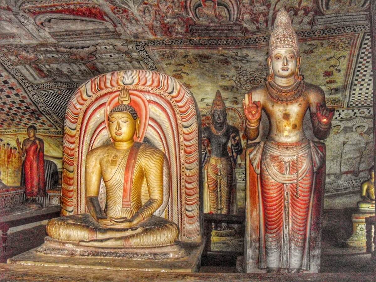 Sitting Buddha and standing God in Dambulla cave close to Anuradhapura