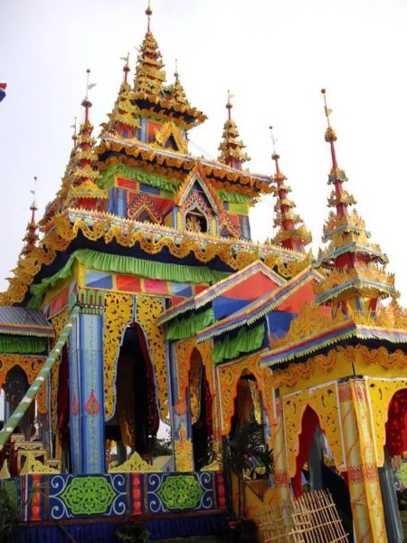 Life size temple in yellow, blue and orange wallpaper in which the cremation will take place