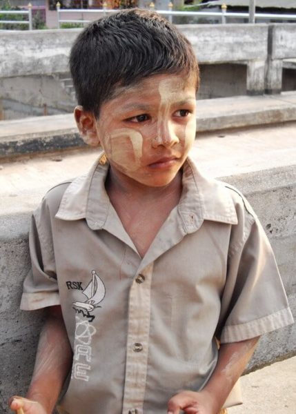 A little Burmese boy wearing thanaka on his cheeks and forehead