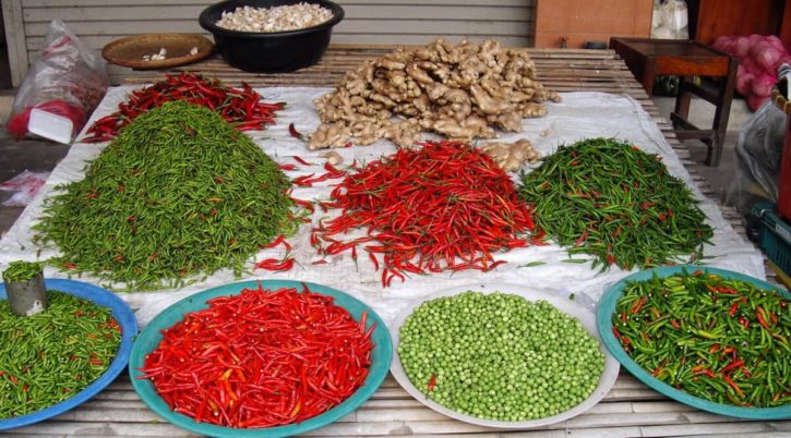 Green and red chilli, green peas and ginger on a beautiful market stall