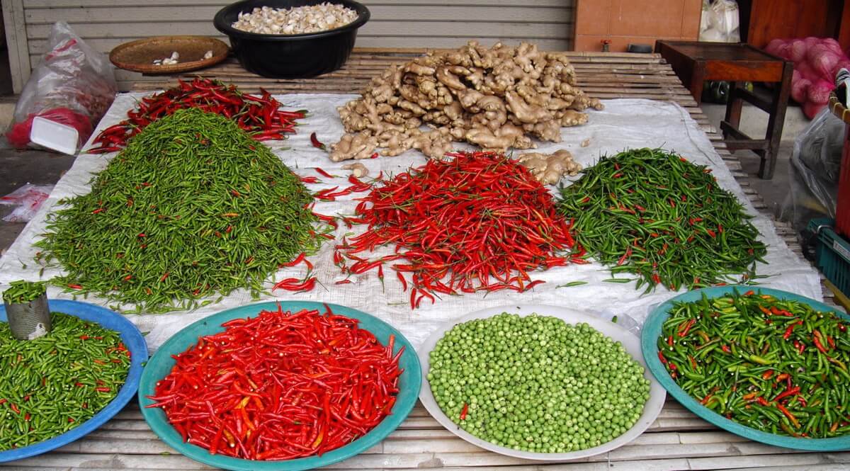 Mae Sot market Thailand Green and red chilli, green peas and ginger on a beautiful market stall
