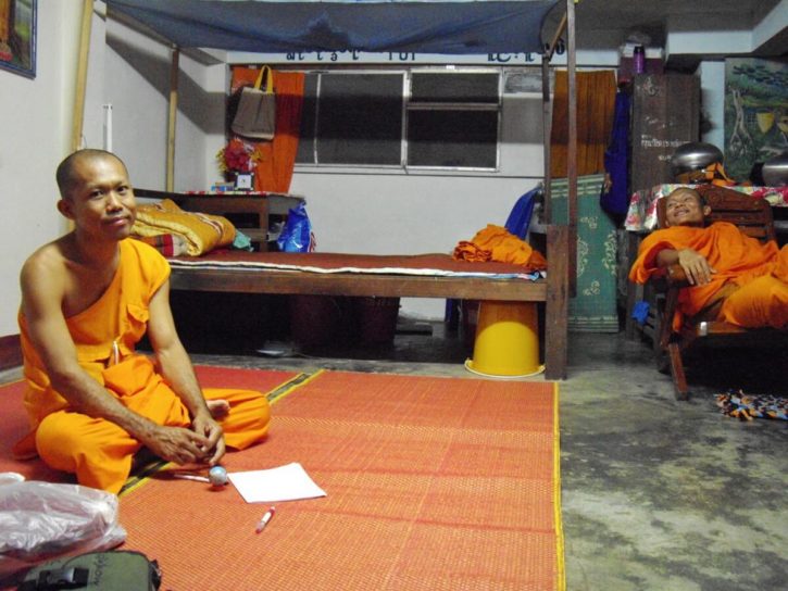 The Burmese monk Nyne Chang on the ground and his friend Pyna Wan Tha on a chair in Nyne Chang's monk cell