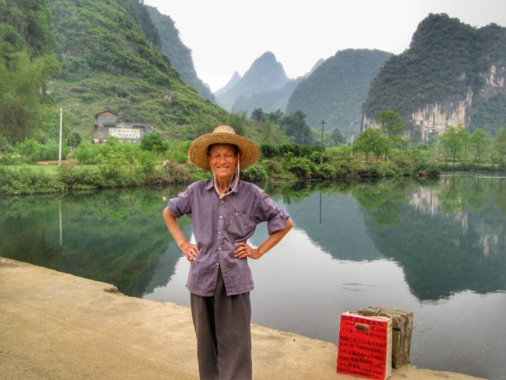 The old man posing in front of Li River and the karst peaks