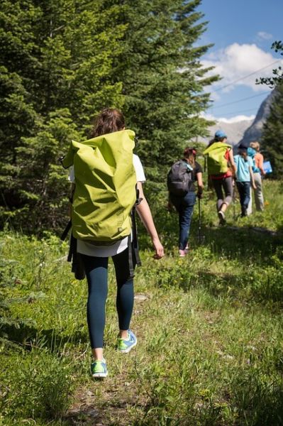 A family carrying hiking backpacks