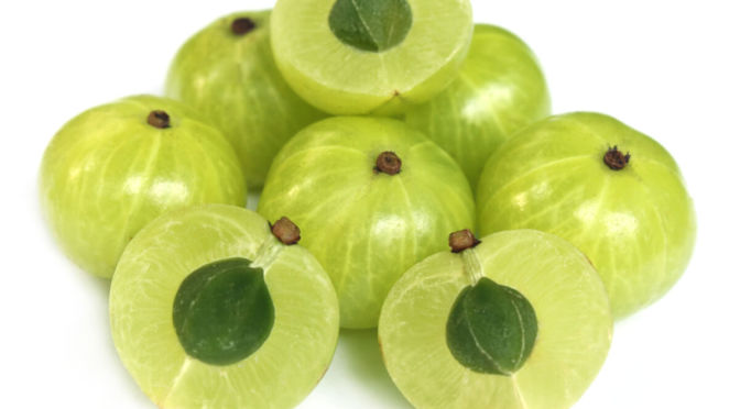 Amla fruit or Indian gooseberry cut into two pieces