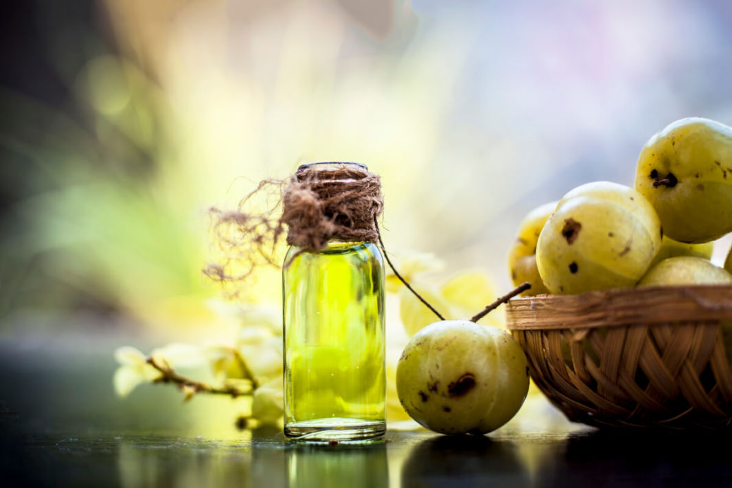 A pure amla oil bootle with fruits