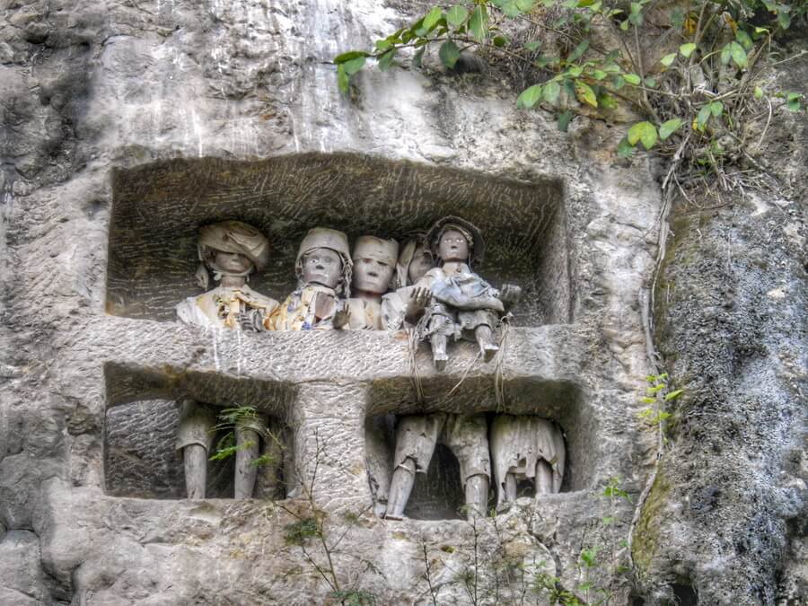 Torajan Tau Tau in the cliff of Suaya close to Rantepao