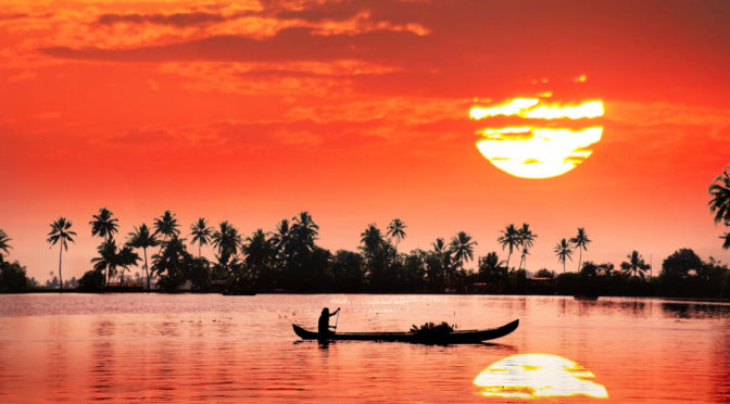 Little boat with Kerala sunset and coconut trees