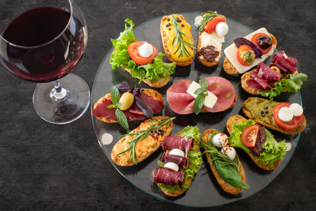 Basque tapas on a plate with a glass of red wine