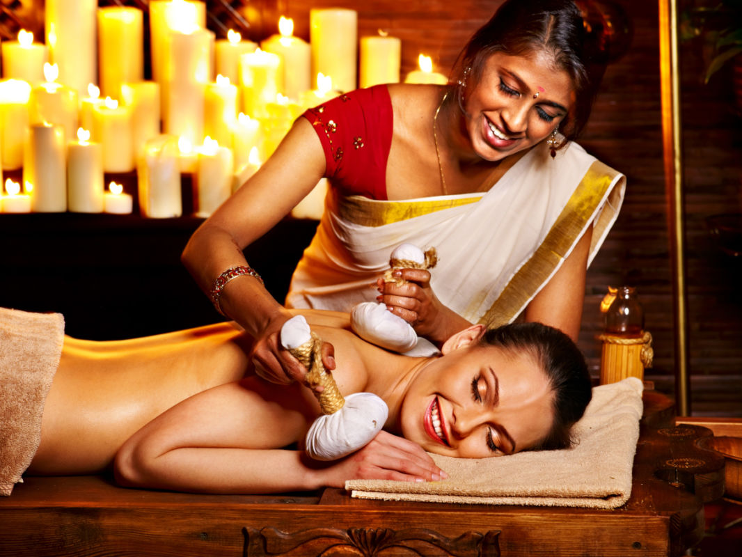 Woman having massage with pouch of rice.