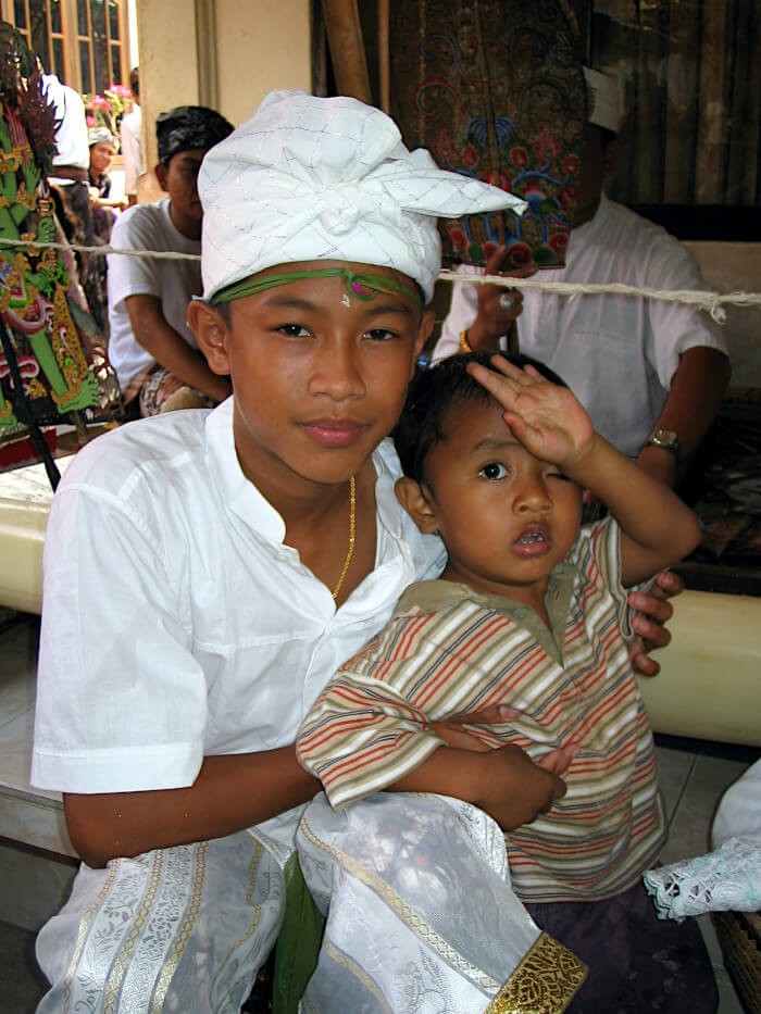 Young Balinese boy wearing the traditional big birthday attire